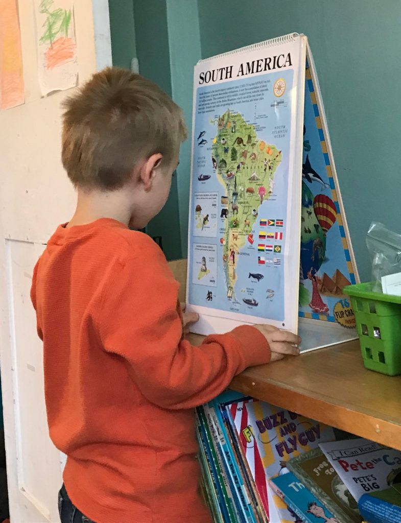 Kyle studies the map of South America during free time